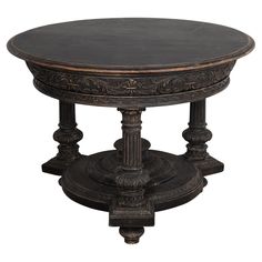 an ornately carved wooden table with black marble on the top and bottom, against a white background