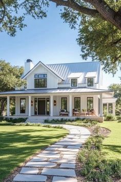 a white house with a walkway leading to the front door