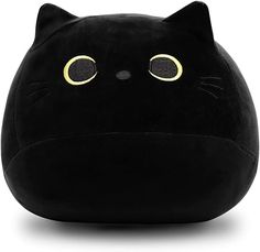 a black cat pillow with yellow eyes on it's head and ears, sitting in front of a white background