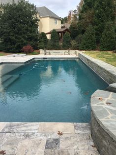 an empty swimming pool surrounded by stone steps