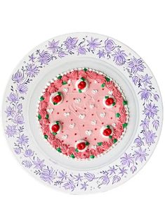 a pink cake on a white plate with flowers and hearts