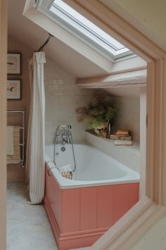 a bath tub sitting under a window in a bathroom