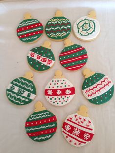 decorated christmas cookies are arranged on a table