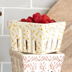 raspberries are stacked on top of each other in this kitchen scene with white tiles