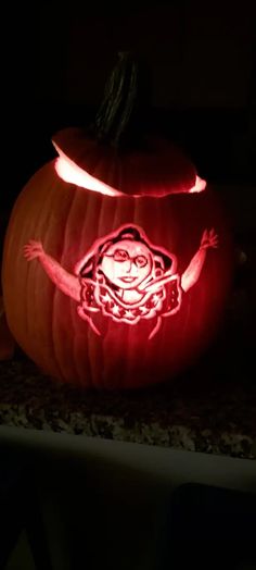 a carved pumpkin with an image of a person on it