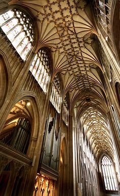 the interior of a cathedral with vaulted ceilings and stained glass windows