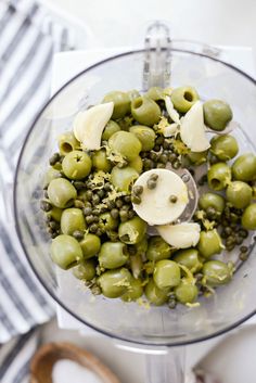 green olives and other ingredients in a food processor