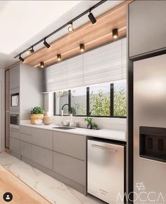 a modern kitchen with stainless steel appliances and white counter tops