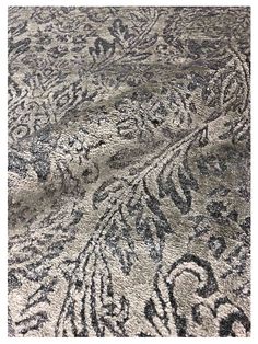 an area rug with black and white designs on it's surface, in the middle of