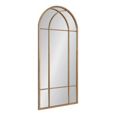 an arched window mirror with gold frame and clear glass, on a white wall background