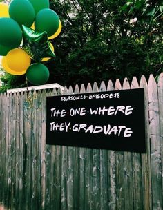 a sign that reads the one where they graduate with balloons in the air behind it