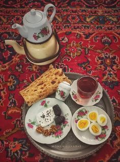 a tray with some food on it next to a tea pot