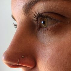 a woman's nose has a piercing on it