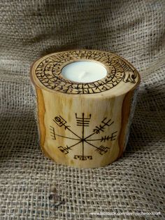 a wooden candle holder sitting on top of a table