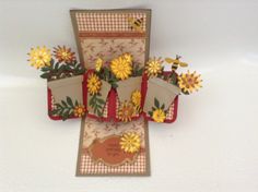 an open card with flowers and bees on it