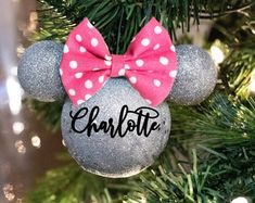 a minnie mouse ornament hanging from a christmas tree with the name charlotte on it