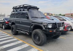 an suv parked in a parking lot next to other cars