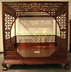 an ornate wooden bed frame on display in a museum