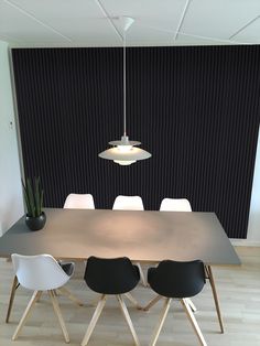 a table with four chairs and a lamp hanging over it