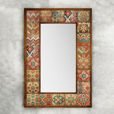 a mirror that is sitting on top of a wall next to a cement floor with a tile border around it