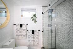 a white bathroom with black and white towels