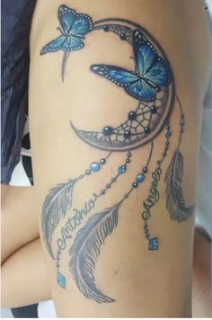 a woman's thigh with blue butterflies and a crescent moon tattoo on the side