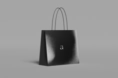 a black shopping bag with the letter s on it's front and side handles