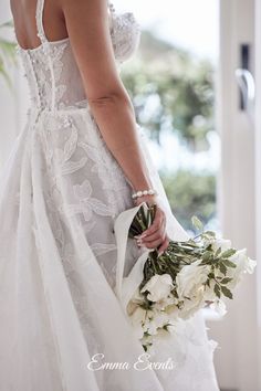 a woman in a wedding dress holding a bouquet