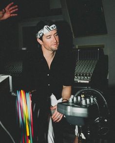 a man sitting in front of a mixing desk