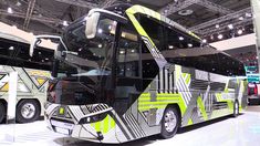 a large bus is on display at an auto show