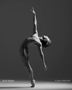 black and white photograph of a man doing a handstand in the middle of his body