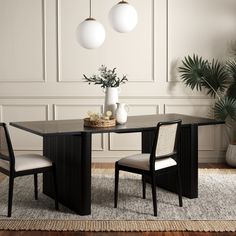 a dining table with two chairs and a vase on it in front of a white wall