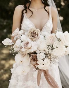 a bride holding a bouquet of flowers in her hands