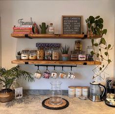 two wooden shelves above a kitchen counter filled with coffee