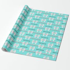 an aqua wrapping paper with white bows on it