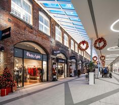 the inside of a shopping mall with christmas decorations