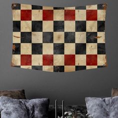 an old checkerboard wall hanging in a living room