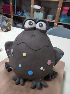 a cake shaped like a frog sitting on top of a table