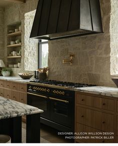 a kitchen with an oven, stove and counter tops in it's center island