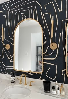 a bathroom sink with a mirror and two faucets on the wall next to it