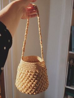 a person holding a woven basket in their hand