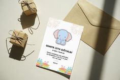 an elephant themed birthday party is set up on the table next to some gift boxes