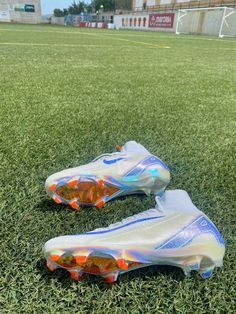 a pair of soccer cleats sitting on top of a field