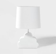 a white table lamp with a cloud shaped shade