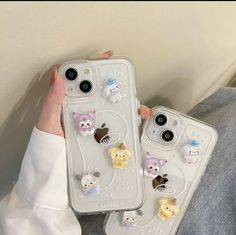 two iphone cases with cats and kittens on them, one is holding the other