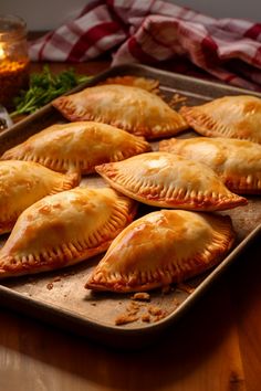 several pastries are on a baking tray ready to be baked in the oven and served