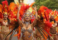 women in colorful costumes are dancing on the street