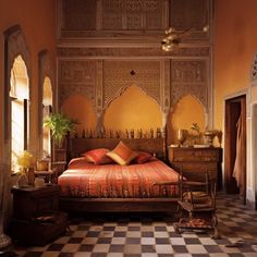 a bed sitting in the middle of a bedroom next to a dresser and mirror on top of a tiled floor