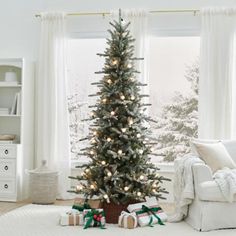 a living room with a christmas tree in the corner