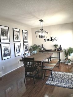 a dining room table with chairs and pictures on the wall above it that says gather